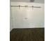 Bedroom boasts sliding closet doors and dark wood-look floors at 6519 Shadowbrook Run, Lakeland, FL 33813