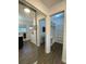 Hallway view to closet with sliding doors and bathroom at 6519 Shadowbrook Run, Lakeland, FL 33813