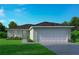 Charming single-story home with a two-car garage, manicured lawn, and vibrant landscaping at 756 Pelican Ct, Poinciana, FL 34759