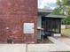 View of the exterior brick chimney and enclosed patio from the spacious backyard at 5801 Poinciana Ave, Lakeland, FL 33809