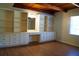 Bedroom with hardwood floors, window, and custom built-in storage and shelving for optimal organization at 5801 Poinciana Ave, Lakeland, FL 33809