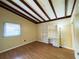 Bedroom with new wood floor, a built-in desk with bookshelves, and cozy charm, creating an inspiring space at 5801 Poinciana Ave, Lakeland, FL 33809