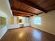Spacious bedroom featuring hardwood floors, custom built-ins, a window, and a unique wood ceiling at 5801 Poinciana Ave, Lakeland, FL 33809