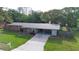 Inviting single-story home with a covered carport, beautiful landscaping, and a well-maintained front yard at 5801 Poinciana Ave, Lakeland, FL 33809
