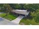 Charming single-story home with a covered carport, lush green lawn, mature trees, and a welcoming curb appeal at 5801 Poinciana Ave, Lakeland, FL 33809