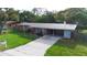 Attractive single-story home featuring a covered carport, a lush lawn, and a neatly landscaped front yard at 5801 Poinciana Ave, Lakeland, FL 33809