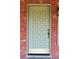 Close-up featuring stylish front door, brick accents and elegant hardware details at 5801 Poinciana Ave, Lakeland, FL 33809
