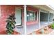 Charming brick home featuring a stylish front door, tiled porch, and manicured landscaping at 5801 Poinciana Ave, Lakeland, FL 33809