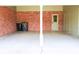 Covered garage with concrete floor and red brick wall at 5801 Poinciana Ave, Lakeland, FL 33809