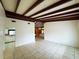 Spacious living room featuring tile floors and a distinctive beamed ceiling design at 5801 Poinciana Ave, Lakeland, FL 33809