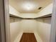 A walk-in closet with shelves and a light overhead at 5801 Poinciana Ave, Lakeland, FL 33809