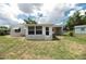 Backyard view of the house featuring a screened-in porch and fenced yard at 760 Formosa Ave, Bartow, FL 33830
