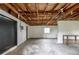 Spacious basement with exposed wooden beams, concrete floor, and a utility sink, ready for customization at 760 Formosa Ave, Bartow, FL 33830