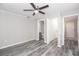 Neutral bedroom with wood-look floors, a ceiling fan and access to the bathroom and closet at 760 Formosa Ave, Bartow, FL 33830