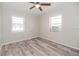 Bedroom with wood-look flooring, ceiling fan, and windows providing plenty of natural light at 760 Formosa Ave, Bartow, FL 33830