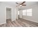 Comfortable bedroom with wood-look flooring, ceiling fan, bathroom, and closet at 760 Formosa Ave, Bartow, FL 33830