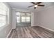 Bright bedroom features wood-look flooring, ceiling fan and slider to Florida room at 760 Formosa Ave, Bartow, FL 33830