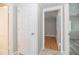 Hallway showcasing multiple doorways with hardwood floors and neutral walls for a functional transition at 760 Formosa Ave, Bartow, FL 33830