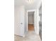 Hallway showcasing multiple doorways with hardwood floors and neutral walls for a functional transition at 760 Formosa Ave, Bartow, FL 33830
