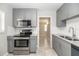 Well-equipped kitchen features gray cabinets, stainless appliances, and granite counters at 760 Formosa Ave, Bartow, FL 33830