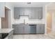 Kitchen featuring gray cabinets, granite countertops, and stainless steel dishwasher at 760 Formosa Ave, Bartow, FL 33830