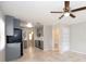 Spacious kitchen with gray cabinets, stainless appliances, tile floors, and a ceiling fan above at 760 Formosa Ave, Bartow, FL 33830
