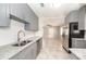 Spacious kitchen featuring granite countertops, stainless steel appliances, and grey cabinets at 760 Formosa Ave, Bartow, FL 33830