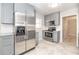 Stylish kitchen equipped with stainless steel appliances, grey cabinets, and granite countertops at 760 Formosa Ave, Bartow, FL 33830