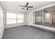 Enclosed sunroom with brick accent wall, carpet, ceiling fan and sliding glass doors at 760 Formosa Ave, Bartow, FL 33830