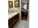 Bright bathroom featuring double sinks, ample counter space and an open view to the bedroom at 925 Fenton Ln # 11, Lakeland, FL 33809