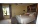 Bright bedroom features a gray four-poster bed, carpeted floors, and a window with curtains at 925 Fenton Ln # 11, Lakeland, FL 33809
