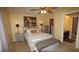 Bright bedroom featuring a bed with grey furniture, lamps, and a glimpse of a bathroom at 925 Fenton Ln # 11, Lakeland, FL 33809