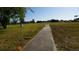 Picturesque community green space featuring a concrete path, perfect for walking or enjoying nature at 925 Fenton Ln # 11, Lakeland, FL 33809