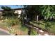 Charming exterior view with mature landscaping, outdoor seating, and a welcoming garden path at 925 Fenton Ln # 11, Lakeland, FL 33809