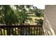 Scenic view of a serene pond, lush greenery, and mature trees from a private balcony at 925 Fenton Ln # 11, Lakeland, FL 33809