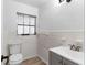 Bathroom with toilet, window, sink, and updated gray vanity at 1586 Fergason Ave, Deltona, FL 32725