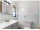 Bathroom featuring an updated vanity, toilet and tiled shower and walls at 1586 Fergason Ave, Deltona, FL 32725