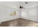 Bright bedroom featuring new flooring, a ceiling fan, and two windows at 1586 Fergason Ave, Deltona, FL 32725