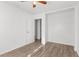 Bright bedroom features wood-look floors, a ceiling fan, closet, and an open door at 1586 Fergason Ave, Deltona, FL 32725