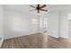 Simple bedroom featuring new flooring, a ceiling fan, and one window at 1586 Fergason Ave, Deltona, FL 32725