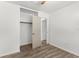 Bedroom features wood-look floors, ceiling fan, and a closet at 1586 Fergason Ave, Deltona, FL 32725