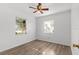 Modest bedroom with laminate floors, ceiling fan and window with blinds at 1586 Fergason Ave, Deltona, FL 32725
