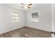 This well-lit bedroom features wood-look floors and two windows at 1586 Fergason Ave, Deltona, FL 32725