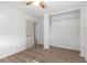 Bedroom with wood-look floors, ceiling fan, and a large closet at 1586 Fergason Ave, Deltona, FL 32725
