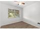 Bedroom featuring wood-look floors and a window for natural light at 1586 Fergason Ave, Deltona, FL 32725