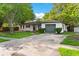 Exterior view of a one-story home with a lush lawn and attached garage at 1586 Fergason Ave, Deltona, FL 32725