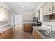 Open kitchen with wood cabinets, stainless appliances, and laminate floors at 1586 Fergason Ave, Deltona, FL 32725
