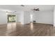 Bright living room featuring wood-look flooring, a ceiling fan, and a large window at 1586 Fergason Ave, Deltona, FL 32725