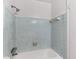 Bathroom shower featuring a tiled surround, shower head and soap dish at 1586 Fergason Ave, Deltona, FL 32725