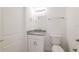 Modern bathroom featuring white cabinetry, granite countertops and brushed nickel hardware at 421 Arkansas Ct, Poinciana, FL 34759